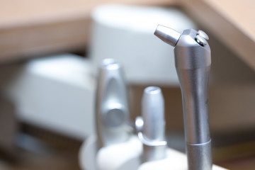 Side view on a water and air syringe in a row of dental tools