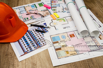 orange helmet, construction drawing, calculator, pen