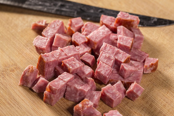 Pieces of sliced italian salami with knife
