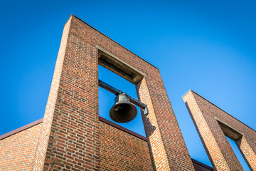Obraz premium The bell at the chapel and crematorium in Oddernes, blue sky above, Kristiansand, Norway