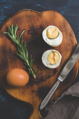 Boiled egg halves on a cutting board.