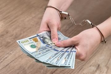 female holds money dollars in handcuffed