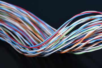 Multicolored electrical cable on dark background