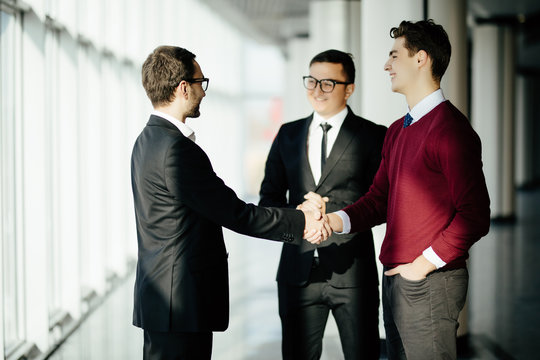Business partners shaking hands in meeting hall. Business meet.