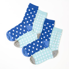 blue polka dotted socks on white background
