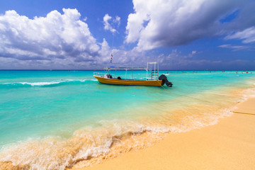 Yellow speedboat on the beach of Caribbean Sea in Mexico.