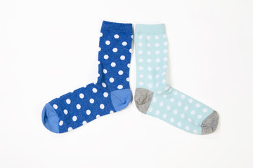 blue polka dotted socks on white background