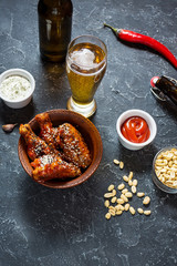 Buffalo style chicken wings served with cold beer