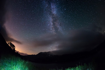 Milky Way arch and the starry sky on the Alps. Fisheye scenic distortion and 180 degree view.