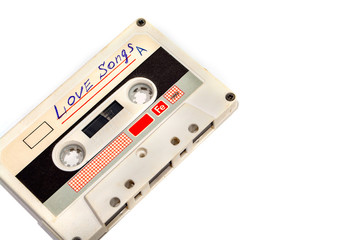Old audio cassette on white background.