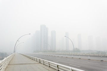 City in a heavy hazy weather. The deterioration of air quality resulted in low horizontal visibility. Located in Sanhao Bridge, Shenyang, Liaoning, China.