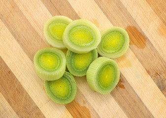 sliced leek isolated on wooden board