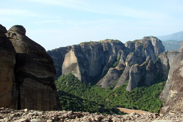 landscape of the rocks of St. Meteors surrounded by mountain forests in the central part of Greece.