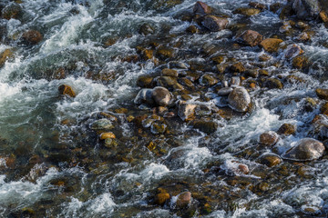 Raging water in threshold of the mountain river