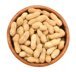 Dried peanuts in wood bowl on white background