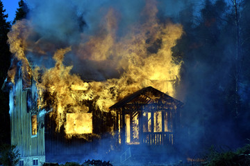 Dark and sad picture of burning house.