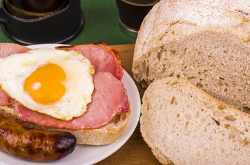 Ulster Fry Breakfast. 
Bacon, Egg, and a sausage sat on a slice of toasted Sour dough bread, with freshly brewed coffee.
