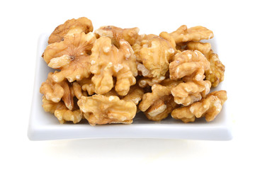 walnut in white bowl on white bakckground