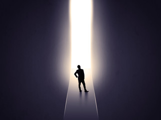 man looking at opened concrete wall