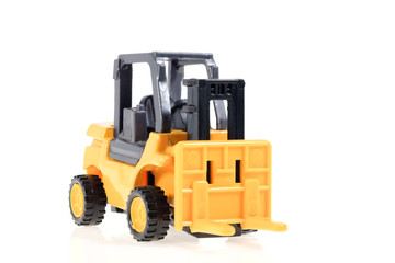 Forklift / Plastic toy forklift on white background.