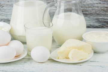 Different dairy products, white wooden background