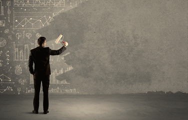 Salesman painting over charts on wall