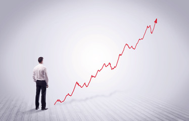Standing businessman with red graph arrow