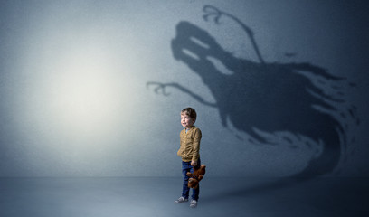 Scary ghost shadow behind kid