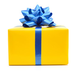 gift yellow box with blue ribbon bow close up isolated on white background