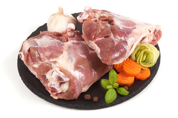 Raw turkey meat on stone plate, isolated on white background.