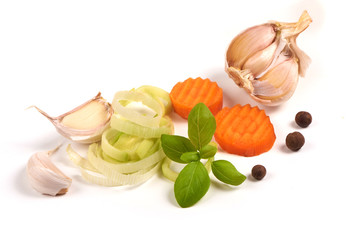 Sliced vegetables with spices, isolated on white background.