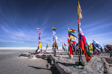 Uyuni Salt Flats - July 20, 2017: Flags landmark at the Uyuni Salt Flats, Bolivia