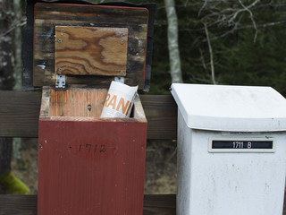 Old white and red mailboxes in the one of them