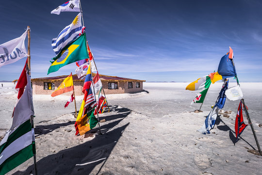 Uyuni Salt Flats - July 20, 2017: Flags landmark at the Uyuni Salt Flats, Bolivia