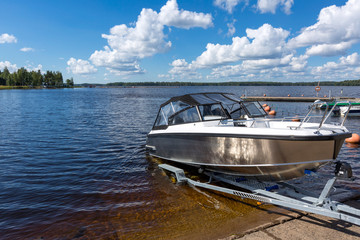 Fototapeta premium Boat launch on lake water