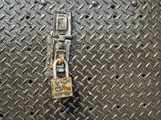 Rusted lock iron padlock on metal door security concept