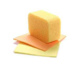 Yellow sponge and clean cloths isolated on white background
