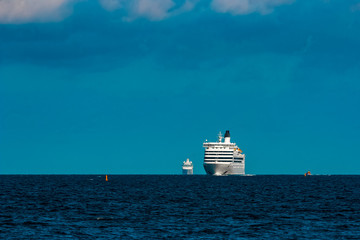 White cruise liner far in sea