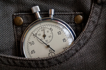 Vintage antiques Stopwatch, in worn brown jeans pocket, value measure time, old clock arrow minute, second accuracy timer record