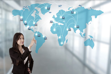business woman pointing to the map with computer network