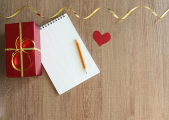 white notepad and red gift box