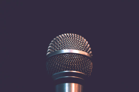 Audio microphone isolated on dark background