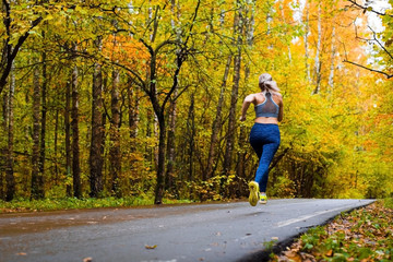 Woman running in the autumn park