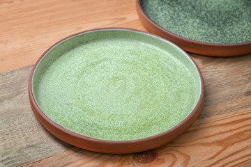 Ceramic plate on wooden background