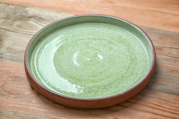Ceramic plate on wooden background