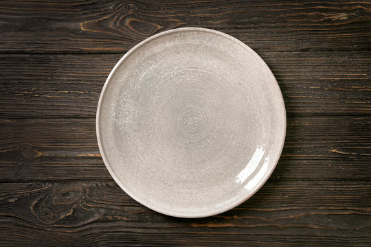Ceramic plate on wooden background