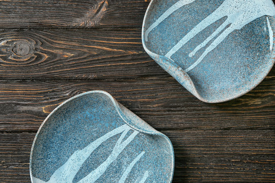 Ceramic plates on wooden background