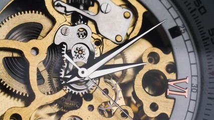 Mechanical golden retro skeleton watch with visible spinning gears and ticking as the hands move around 