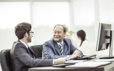 Fototapeta premium members of a business team discussing business documents in the workplace in the office