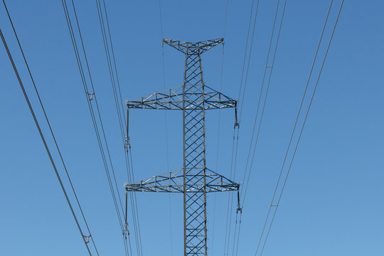 A power line wires against blue sky